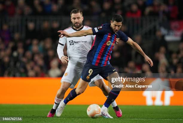 Luke Shaw of Manchester United battles for possession with Robert Lewandowski of FC Barcelona during the UEFA Europa League knockout round play-off...