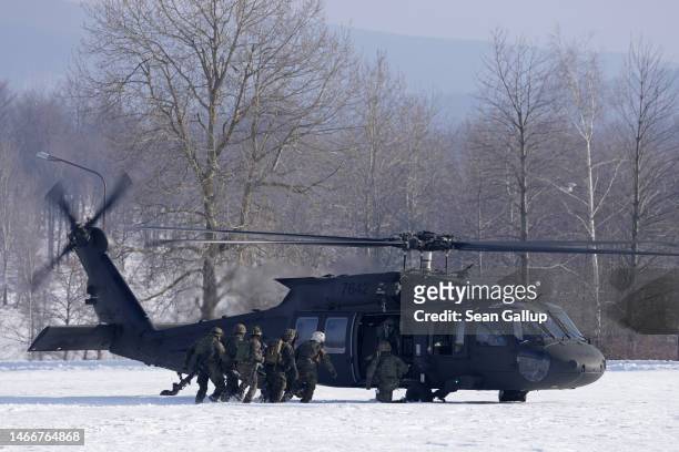 Soldiers of the Bundeswehr, the German armed forces, evacuate a wounded comrade as a simulation to a UH-60 Black Hawk helicopter of the Slovak...