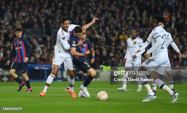 Raphael Varane of Manchester United battles for possession with Robert Lewandowski of FC Barcelona during the UEFA Europa League knockout round...