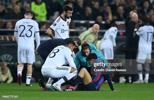 Pedri of FC Barcelona receives medical treatment during the UEFA Europa League knockout round play-off leg one match between FC Barcelona and...