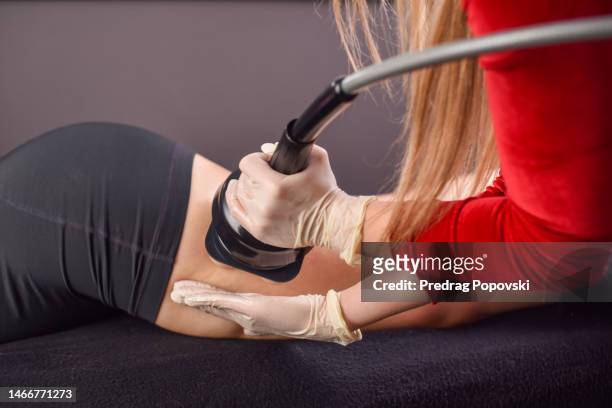 woman getting massage treatment in spa with cellulite machine - cellulit bildbanksfoton och bilder