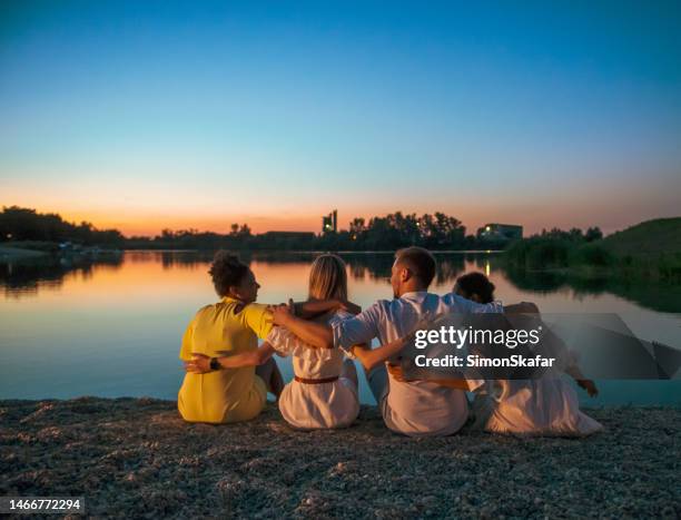 friends spending leisure time at lakeshore - slovenia beach stock pictures, royalty-free photos & images