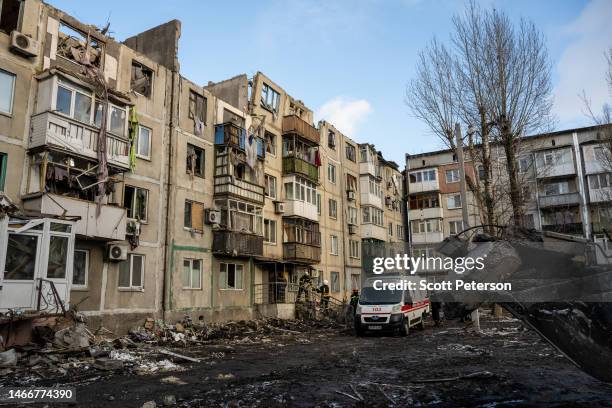 Ukrainian emergency workers pull down and ensure safety of residential apartment building struck by a Russian missile that exploded mid-morning the...