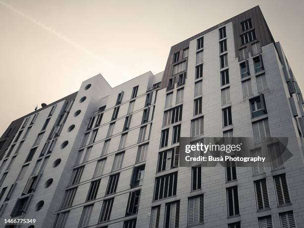 toned image of modern public housing buildings - cladding stock pictures, royalty-free photos & images