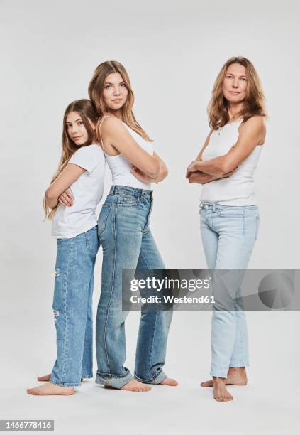 confident family standing together against white background - mom arms crossed stock pictures, royalty-free photos & images