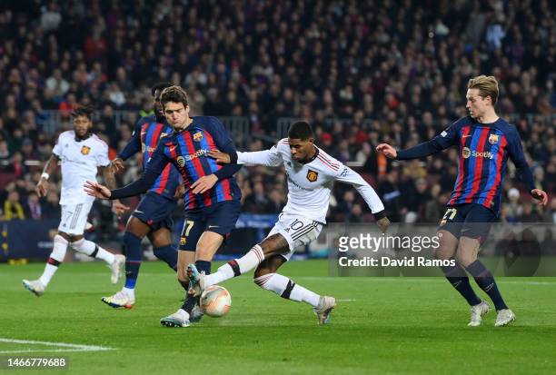 Marcus Rashford of Manchester United is challenged by Marcos Alonso of FC Barcelona during the UEFA Europa League knockout round play-off leg one...