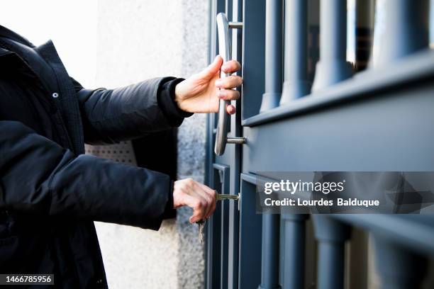 cropped hand of woman opening door - house door stock pictures, royalty-free photos & images