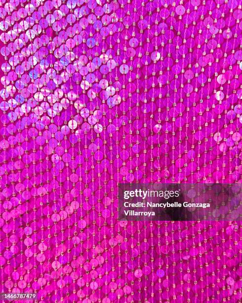 multi shades of  pink  sequins on a fabric - warm roze stockfoto's en -beelden