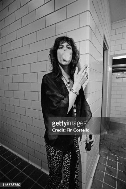 30th MAY: lead singer Steven Tyler from American rock band Aerosmith smokes a cigarette backstage at RFK Stadium in Washington DC, USA on 30th May...