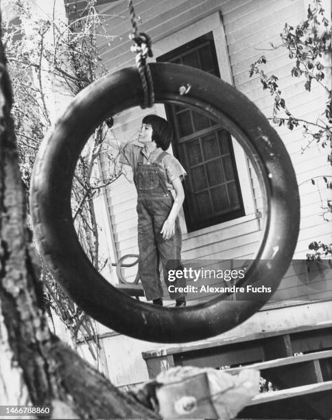 Actress Mary Badham photographed through a tire in the set of To Kill A Mockingbird, in 1961 at Monroeville, Alabama.