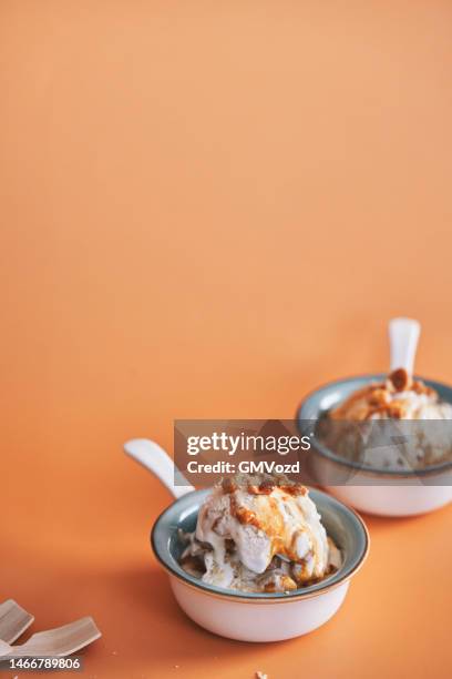 caramel ice cream with topping - caramel sauce stock pictures, royalty-free photos & images