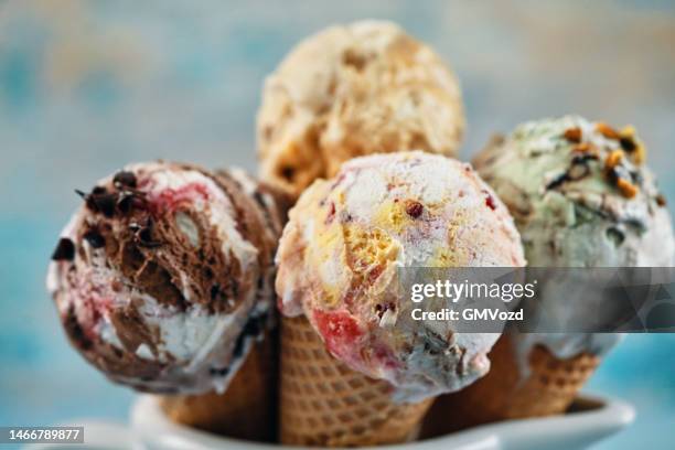 pistachio, chocolate, strawberry and vanilla ice cream in a cone - icecream stock pictures, royalty-free photos & images