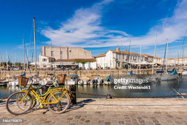 france, nouvelle-aquitaine, saint-martin-de-re, various boats moored in town harbor - charente maritime stock pictures, royalty-free photos & images