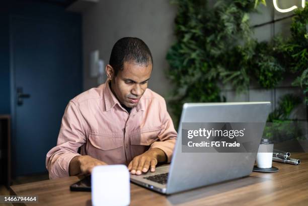 visually impaired man using the laptop in the office - blind stock pictures, royalty-free photos & images