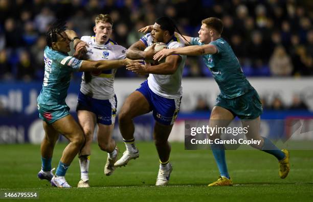 Thomas Mikaele of Warrington is tackled by Morgan Gannon of Leeds during the Betfred Super League between Warrington Wolves and Leeds Rhinos at The...