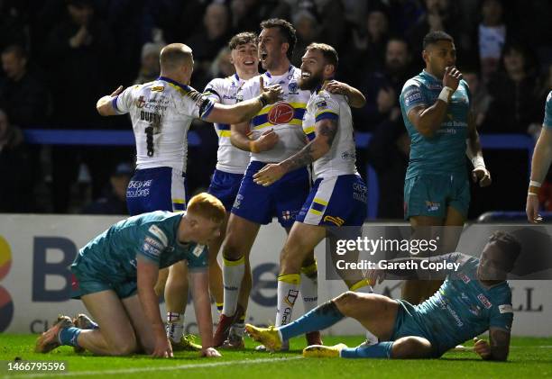 Daryl Clark of Warrington celebrates scoring his team's second try during the Betfred Super League between Warrington Wolves and Leeds Rhinos at The...