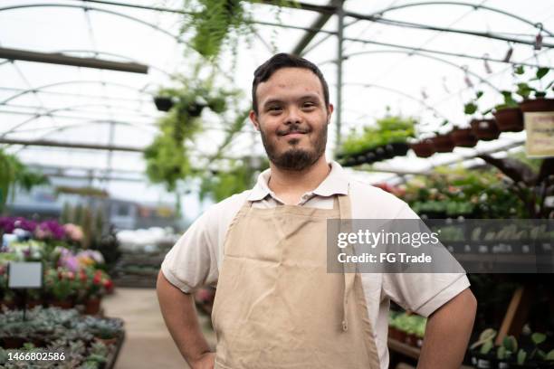 portrait of a young special needs in a garden center - botany downs stock pictures, royalty-free photos & images