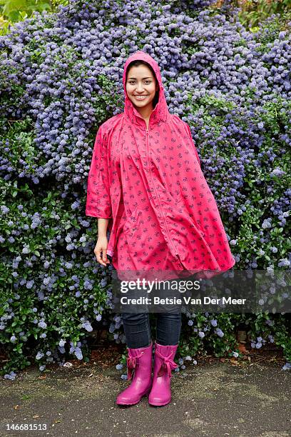 portrait of woman wearing waterproof poncho. - poncho fotografías e imágenes de stock