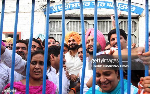 Former Cricketer and BJP MP from Amritsar Navjot Singh Sidhu stands with supporters after leaving Amritsar central jail after his court arrest on...