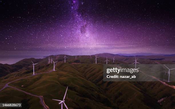 wind farm next to coast at midnight. - new zealand night stock pictures, royalty-free photos & images