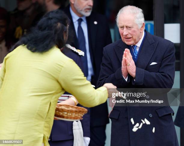 King Charles III makes a namaste hand gesture as he departs after attending a reception for members of the local community and organisations at the...