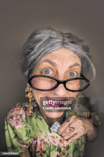 funny fisheye grandma stuffing money in her bra - hidden object stock pictures, royalty-free photos & images