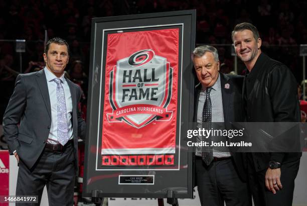 Cam Ward poses with Carolina Hurricanes head coach Rod Brind'Amour and general manager Don Waddell after his induction into the Carolina Hurricanes...