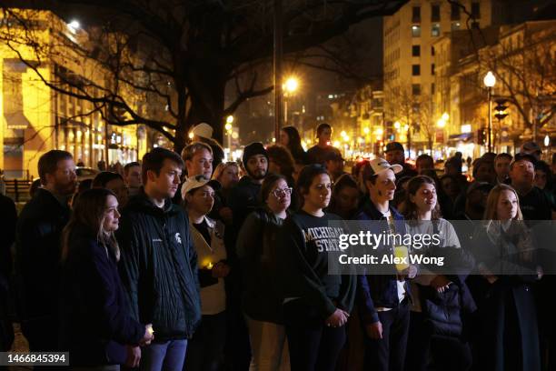 People including alumni and current students of Michigan State University gather for a candlelight vigil, hosted by D.C. Spartans, to remember the...