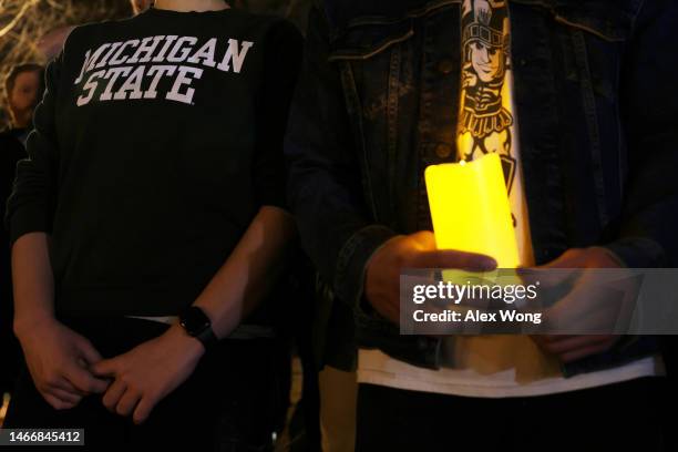 People including alumni and current students of Michigan State University gather for a candlelight vigil, hosted by D.C. Spartans, to remember the...