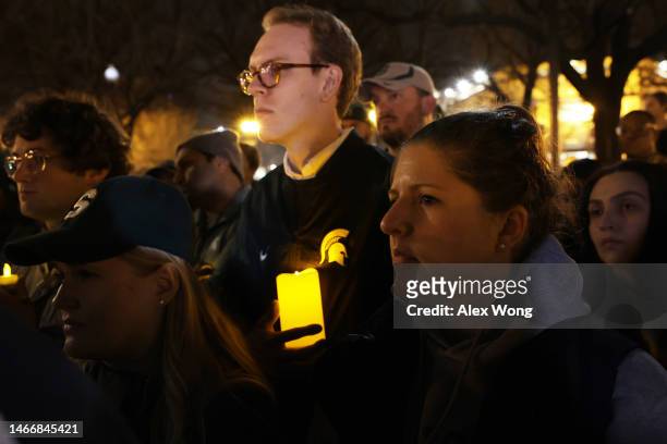 People including alumni and current students of Michigan State University gather for a candlelight vigil, hosted by D.C. Spartans, to remember the...