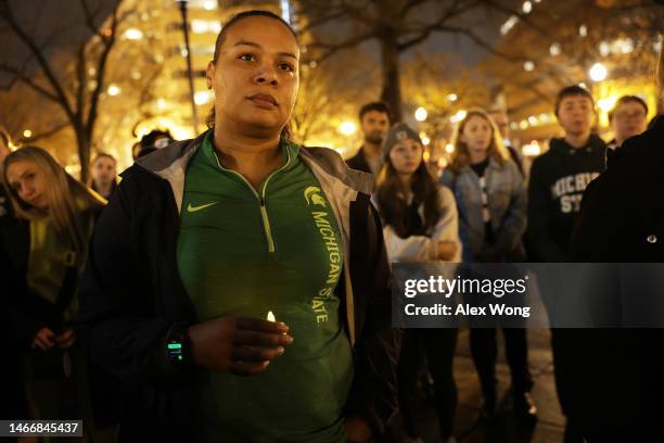 People including alumni and current students of Michigan State University gather for a candlelight vigil, hosted by D.C. Spartans, to remember the...