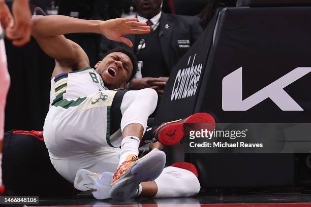 Giannis Antetokounmpo of the Milwaukee Bucks reacts after colliding with the stanchion during the first half against the Chicago Bulls at United...