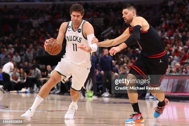Brook Lopez of the Milwaukee Bucks drives to the basket against Nikola Vucevic of the Chicago Bulls during the first half at United Center on...
