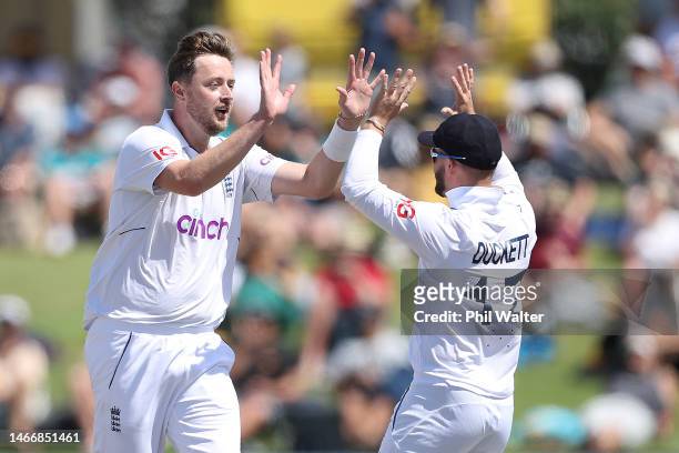 Ollie Robinson of England celebrates his wicket of Daryl Mitchell of New Zealand with Ben Duckett during day two of the First Test match in the...