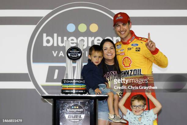 Joey Logano, driver of the Shell Pennzoil Ford, poses with his wife, Brittany and son, Hudson in victory lane after winning the NASCAR Cup Series...
