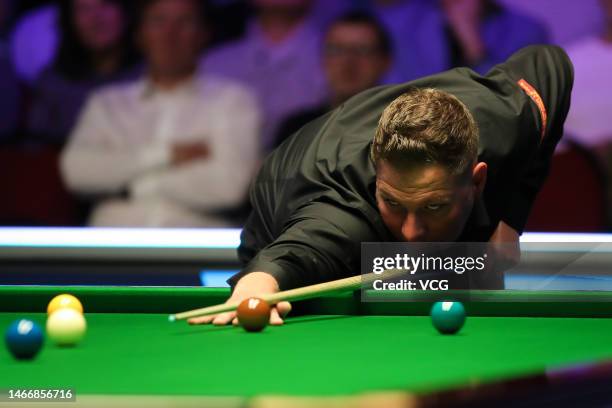 Daniel Wells of Wales plays a shot in the fourth round match against Shaun Murphy of England on day four of 2023 Betvictor Welsh Open at Venue Cymru...