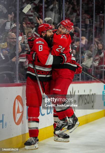 Seth Jarvis of the Carolina Hurricanes celebrates with Brent Burns after scoring a goal during the third period against the Montreal Canadiens at PNC...