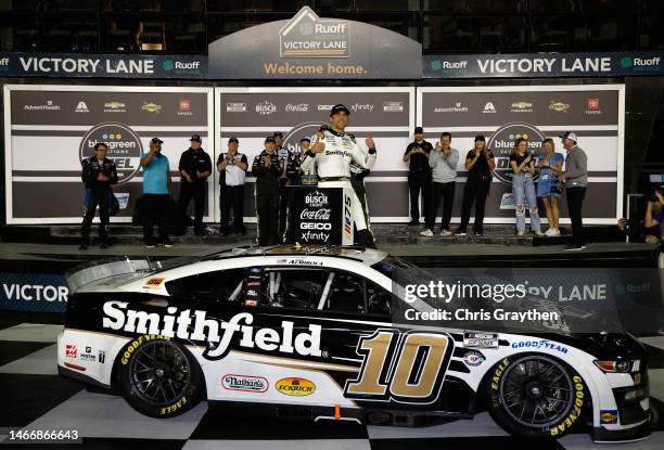 Aric Almirola, driver of the Smithfield Ford, celebrates in victory lane after winning the NASCAR Cup Series Bluegreen Vacations Duel at Daytona...