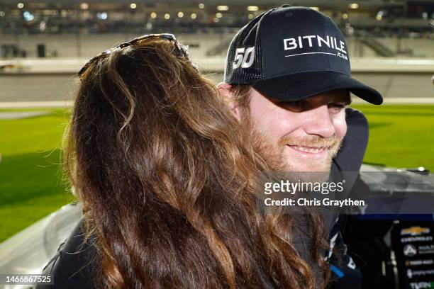 Conor Daly, driver of the BitNile.com Chevrolet, is embraced by his mother, Beth Boles after the NASCAR Cup Series Bluegreen Vacations Duel at...