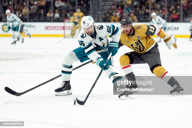 Reilly Smith of the Vegas Golden Knights battles Erik Karlsson of the San Jose Sharks during the first period at T-Mobile Arena on February 16, 2023...