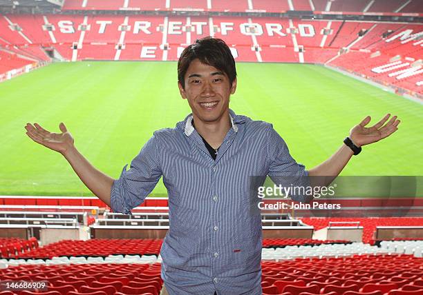 Manchester United's new signing Shinji Kagawa from Borussia Dortmund poses at Old Trafford on June 22, 2012 in Manchester, United Kingdom.