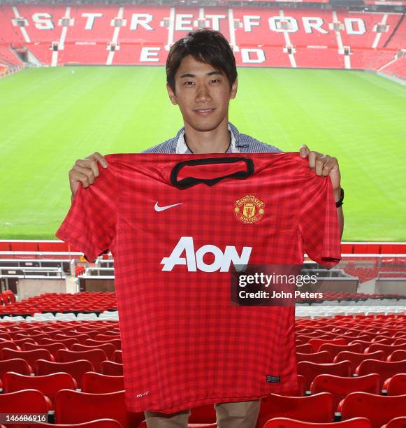 Manchester United's new signing Shinji Kagawa from Borussia Dortmund poses at Old Trafford on June 22, 2012 in Manchester, United Kingdom.