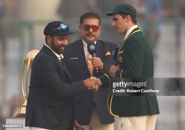 Rohit Sharma of India and Pat Cummins of Australia are seen at the coin toss during day one of the Second Test match in the series between India and...