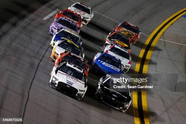 Austin Cindric, driver of the Discount Tire Ford, and Aric Almirola, driver of the Smithfield Ford, lead the field during the NASCAR Cup Series...