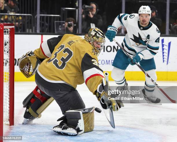 Adin Hill of the Vegas Golden Knights makes a save as Tomas Hertl of the San Jose Sharks looks on in the first period of their game at T-Mobile Arena...