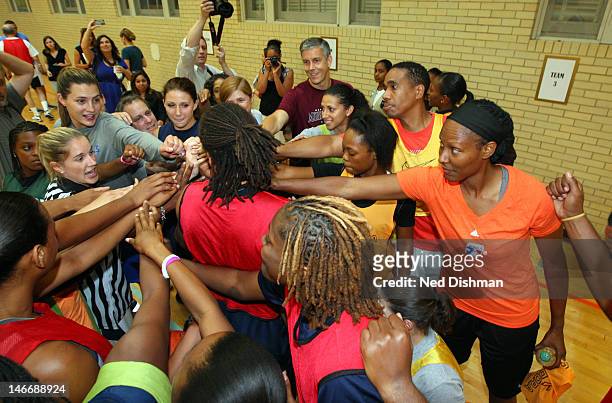 Secretary of Education Arne Duncan and Chamique Holdsclaw are part of a huddle after playing basketball. Senior Administration Officials and Members...