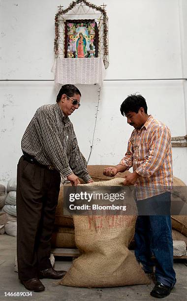 Men check a sack of Pergamino coffee beans at the Xico Coffee facility in Xicontepec, Mexico, on Tuesday, June 19, 2012. Gross domestic product will...