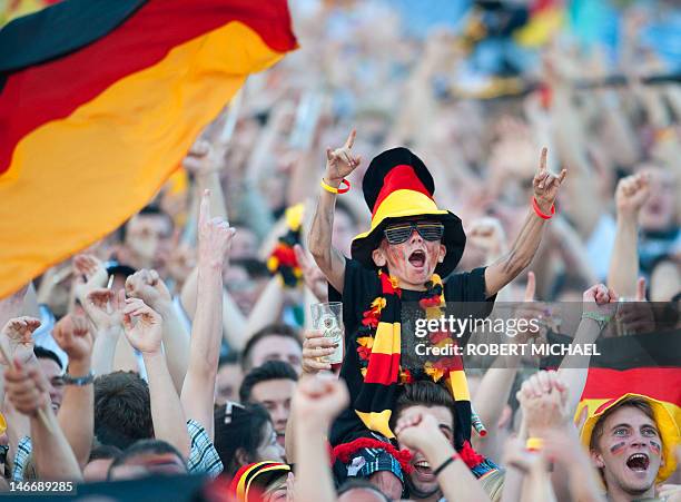 Young fan of the German national football team reacts during a public viewing event showing the EURO 2012 quarter-final football match between...