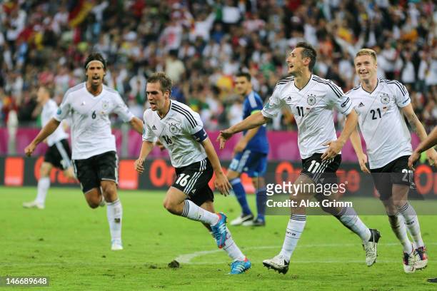 Philipp Lahm of Germany celebrates scoring their first goal with Marco Reus and Miroslav Klose during the UEFA EURO 2012 quarter final match between...