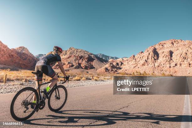 road bicyclist - nevada road stock pictures, royalty-free photos & images